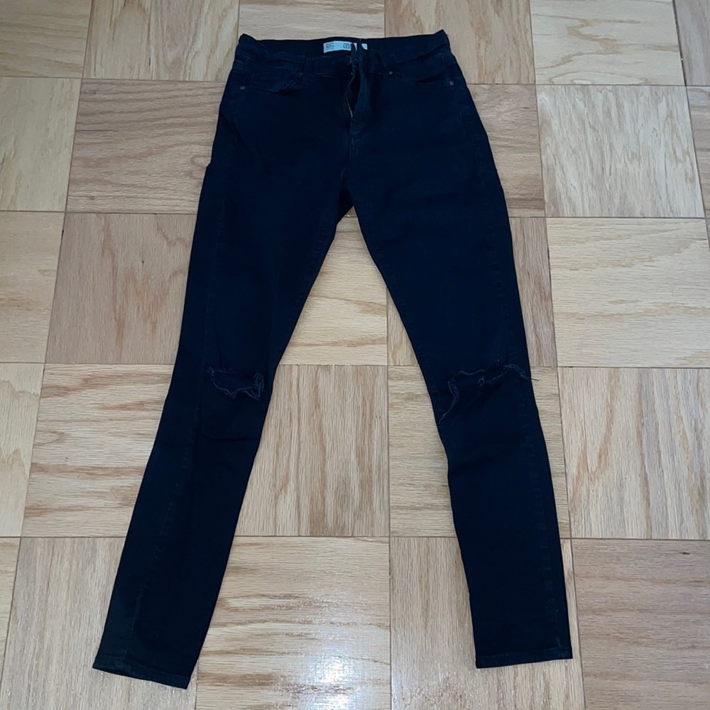 TopShop Skinny black jeans with rips and the knees.